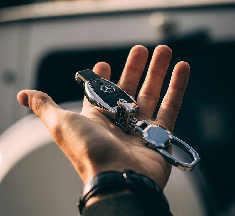 man holding car keys